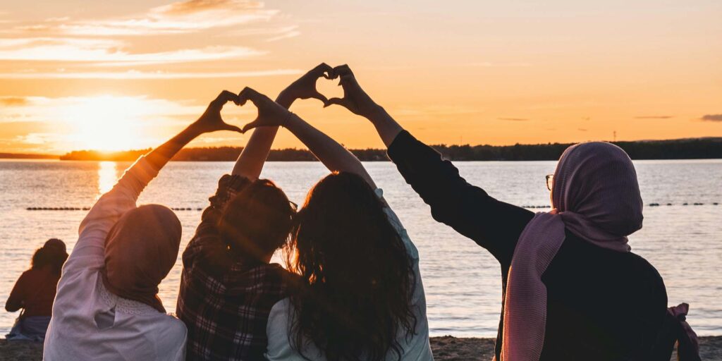 Women creating hearts with their hands